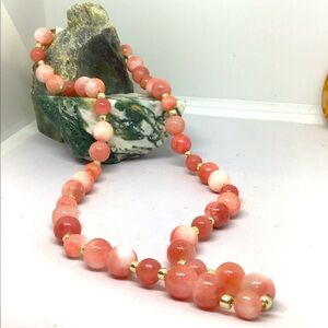 Handmade pink and cream natural colored stone beads with silver spacer beads.